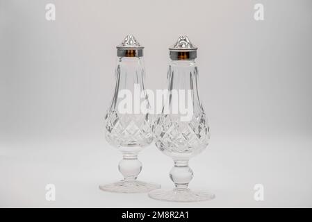 close-up of cut glass crystal salt and pepper shakers with silver tops Stock Photo