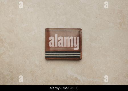 Luxury brown leather wallet on marble background	 Luxury brown leather wallet on marble background Stock Photo