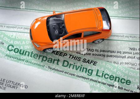 MODEL CAR WITH PAPER COUNTERPART DRIVING LICENCE RE DVLA DRIVERS DRIVING FINES PENALTY POINTS ETC UK Stock Photo