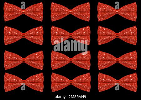 Lots of red shiny bows on a black background. Stock Photo