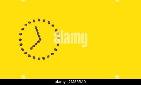 Morning concept. Alarm clock, coffee. Alarm clock on a yellow background from coffee beans. Stock Photo