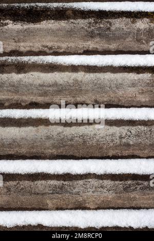 Slate background with snow lying on it. Stock Photo
