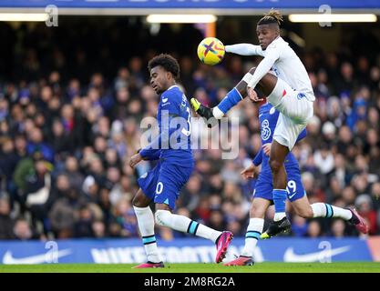 Chelsea's Carney Chukwuemeka and Crystal Palace's Wilfried Zaha battle for the ball during the Premier League match at Stamford Bridge, London. Picture date: Sunday January 15, 2023. Stock Photo