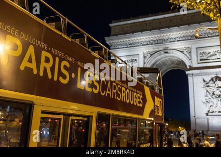 Paris, France - October 26, 2022: Arc de Triomphe and Paris tour bus. Stock Photo