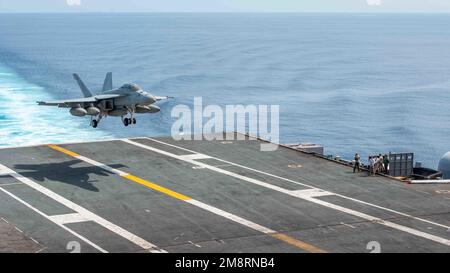 South China Sea, International Waters. 14th Jan, 2023. South China Sea, International Waters. 14 January, 2023. A U.S. Navy F/A-18F Super Hornet fighter aircraft, with the Fighting Redcocks of Strike Fighter Squadron 22 lands on the flight deck of the Nimitz-class aircraft carrier USS Nimitz, January 14, 2023 operating in the South China Sea. Credit: MC3 Caylen McCutcheon/U.S. Navy/Alamy Live News Stock Photo