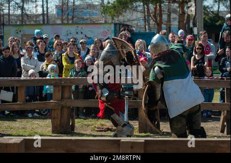 Barnaul - April 22, 2017: Medieval restorers fight with swords in armor at a knightly tournament, historical restoration of knightly fights on April 2 Stock Photo