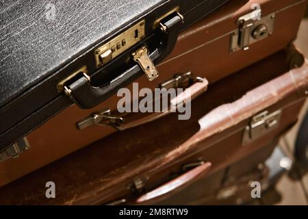 Top view on the stack of old vintage suitcases. Retro suitcases details. Selective focus. Stock Photo
