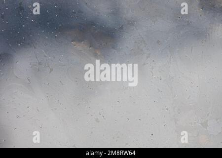 Slime on a lake surface creates a textured background that looks like plastic or acryllic. Stock Photo