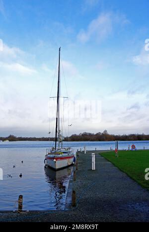 A yacht moored at the staithe in winter on Malthouse Broad on the Norfolk Broads at Ranworth, Norfolk, England, United Kingdom. Stock Photo