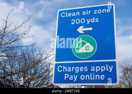 A sign indicates Clean Air Zone (CAZ) charges in the Newcastle upon Tyne and Gateshead areas in the UK.