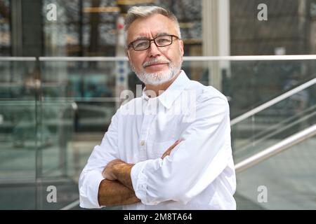 Confident happy mature older senior business man outdoors, portrait. Stock Photo