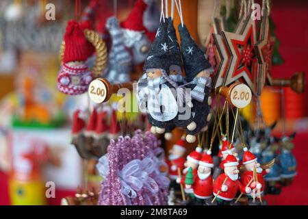 Christmas Santa's on sale in winter market stalls, Germany, Winter 2022 Stock Photo