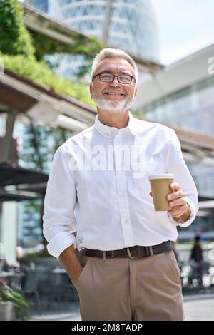 Confident happy mature older business man outdoor vertical portrait. Stock Photo
