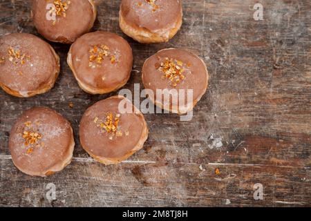 Donuts for Fat Thursday. Polish tradition - fresh donuts with icing and cherry filling Stock Photo