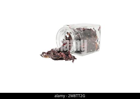 Dry hibiscus tea falling from glass jar isolated on white background. herb. herbal tea. food ingredient. Stock Photo