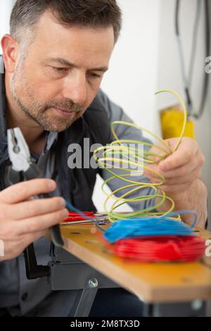 male electrician builder working with cables Stock Photo