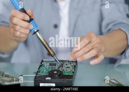 close up view of mans hands repairing printed circuit board Stock Photo