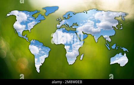 Mirror in the form of world map on green background. Sky reflection. Concept of sustainable development Stock Photo