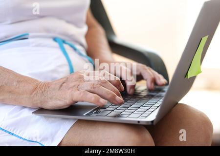 Closeup of aged business woman using computer. Stock Photo