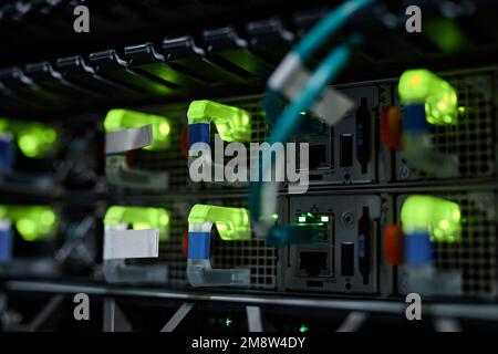 Close up background image of neon indicator lights in server cabinet with internet cables, copy space Stock Photo