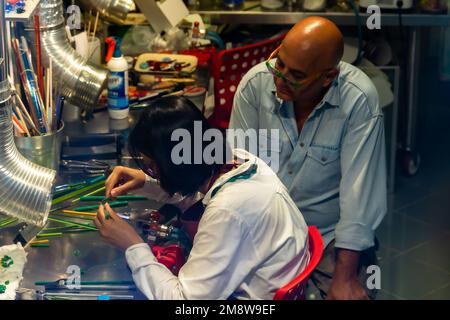 A Jeweler watches over an apprentice in a Venetian workshop Stock Photo