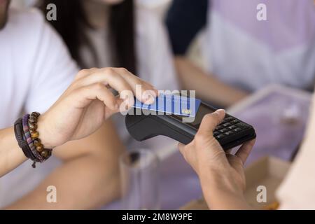 Hand of young man paying for meal in cafe Stock Photo