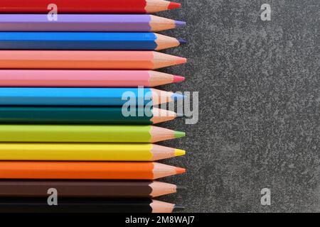 Coloring pencils in many different colors and textured background with copy space for your text. Stock Photo