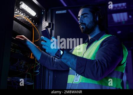 Close up of black man as network technician using control panel while setting up server in data center, copy space Stock Photo