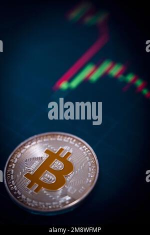Silver Bitcoin cryptocurrency with candle stick graph chart and digital background. Stock Photo