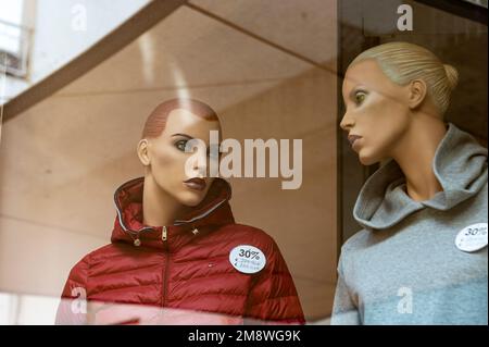 Two female mannequins on display in a clothing shop window. Stock Photo