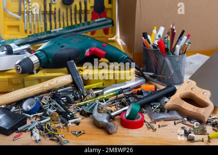 Different screws and tools on the table in the workshop Stock Photo