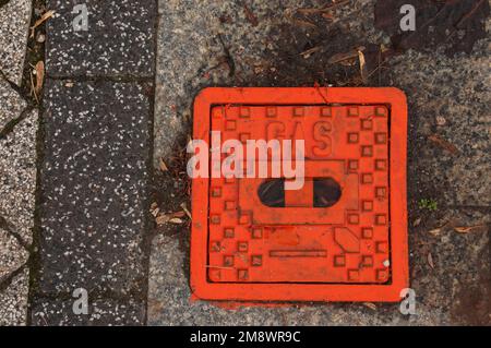 Manhole cover of the gas pipeline system. A massive metal hatch for access to city communications in the pavement. Stock Photo