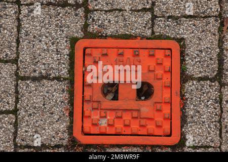 Manhole cover of the gas pipeline system. A massive metal hatch for access to city communications in the pavement. Stock Photo