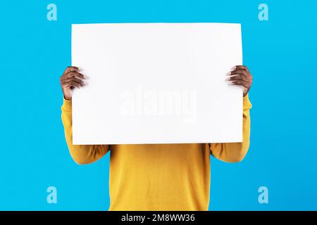 Young African American Man Hiding Face Behind Blank White Placard Stock Photo