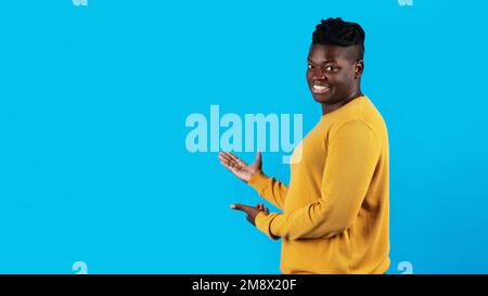 Handsome Young Black Man Pointing At Copy Space With Two Hands Stock Photo