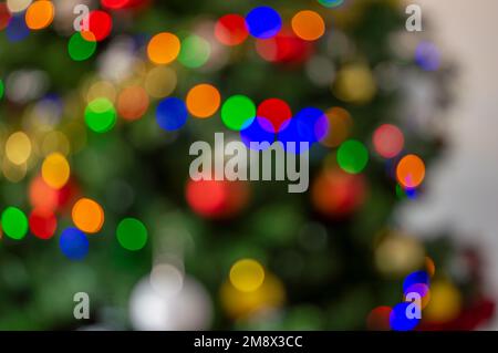 Bright lights on a Christmas tree. Defocused shot of a beautifully decorated Christmas tree Stock Photo