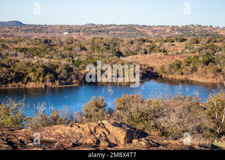 Texas Hill Country hiking trail with a view of Inks Lake. The golden hour sunset panoramic view of Inks Lake State Park Burnet Texas in Autumn. Stock Photo