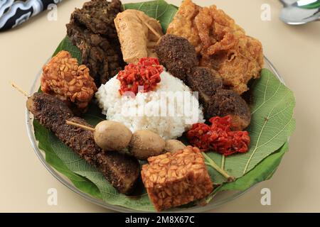 Nasi Jamblang or Sega Jamblang, Cirebon Mix Rice Wrapped with Teak Leaf. Served with Various Side Dish. Stock Photo