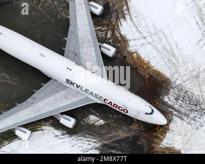 Skylease cargo Boeing 747-400 aircraft parked at Anchorage Airport after snow. Four engines airplane 747-400F of Sky Lease Cargo after snow storm. Stock Photo