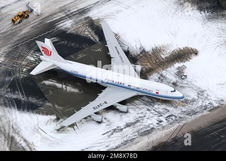 Air China cargo Boeing 747-400 aircraft parked at Anchorage Airport after snow storm. Airplane 747-400F of Air China Cargo after with snow around. Stock Photo