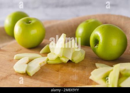 Apple slices close-up on a wooden cutting board. Apples close-up on a kitchen table Stock Photo