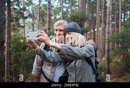 Another selfie about another adventure. a mature couple taking a selfie while out hiking together. Stock Photo