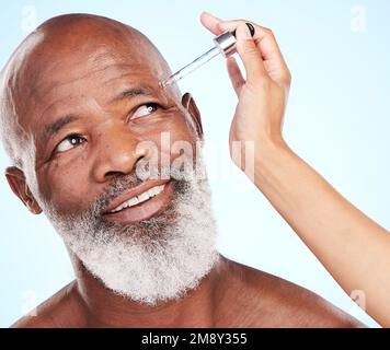 Thisll do the trick. a handsome mature man posing in studio against a blue background. Stock Photo