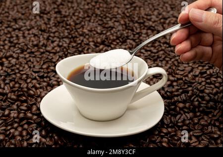 Cup of coffee on brown coffee beans Stock Photo