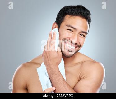 Practicing self-care in any capacity should become a priority. a man drying his face with a towel. Stock Photo