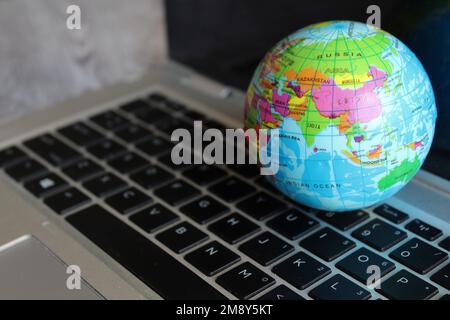 World globe map on top of laptop keyboard. Technology and communication concept Stock Photo