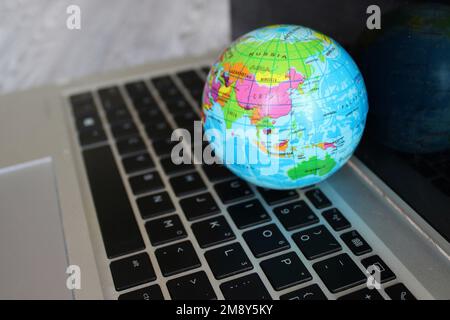 World globe map on top of laptop keyboard. Technology and communication concept Stock Photo