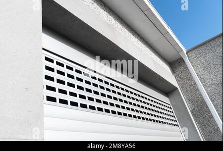 Roller shutter gate. Metal roller garage door as background. Automatic electric roll-up garage gate. Garage with rolling gates. Stock Photo