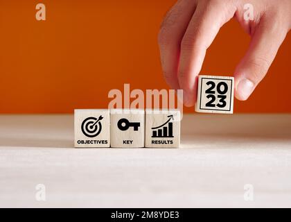 OKR Objectives and Key Results planning in the year 2023 concept on wooden cubes. Business target, growth achievement and performance concept. Stock Photo