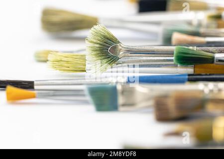 Paint brushes stained with paint, close-up, macro shot. Stock Photo